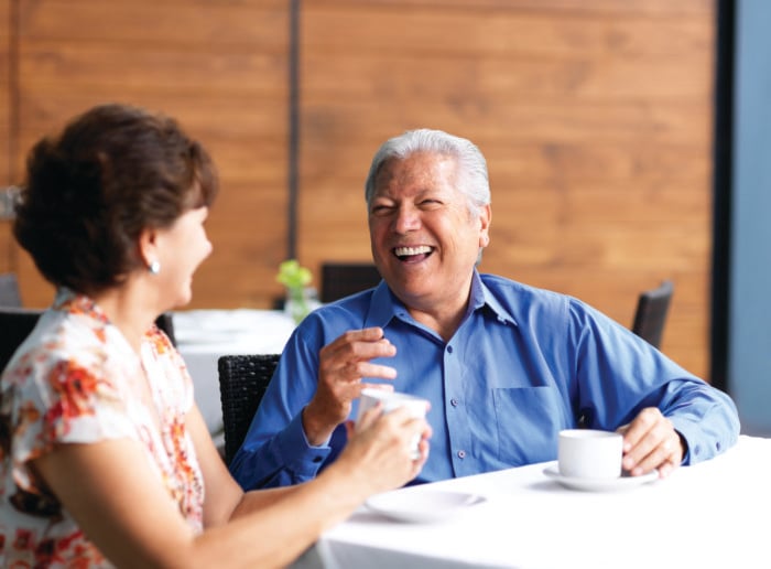 two senior residents enjoying a coffee together