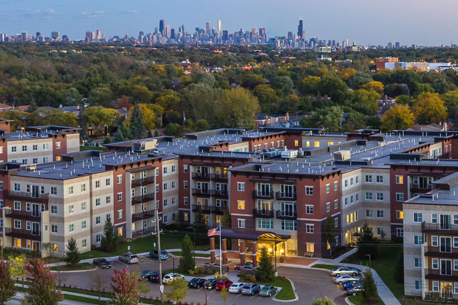 photo of the exterior of The Carrington at Lincolnwood with the Chicago skyline in the background