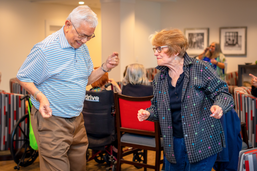 two senior residents dancing with one another at our retirement community