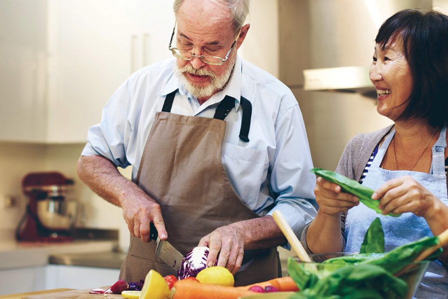 senior residents preparing a meal in their kitchen