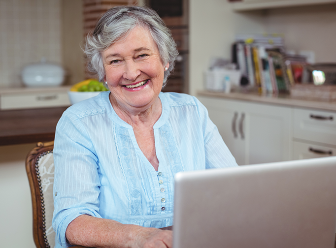 senior woman enjoying browsing the Internet on her laptop