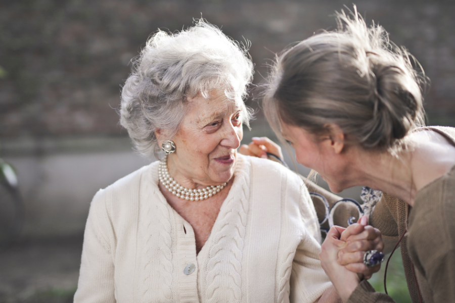 two senior residents embracing eachother