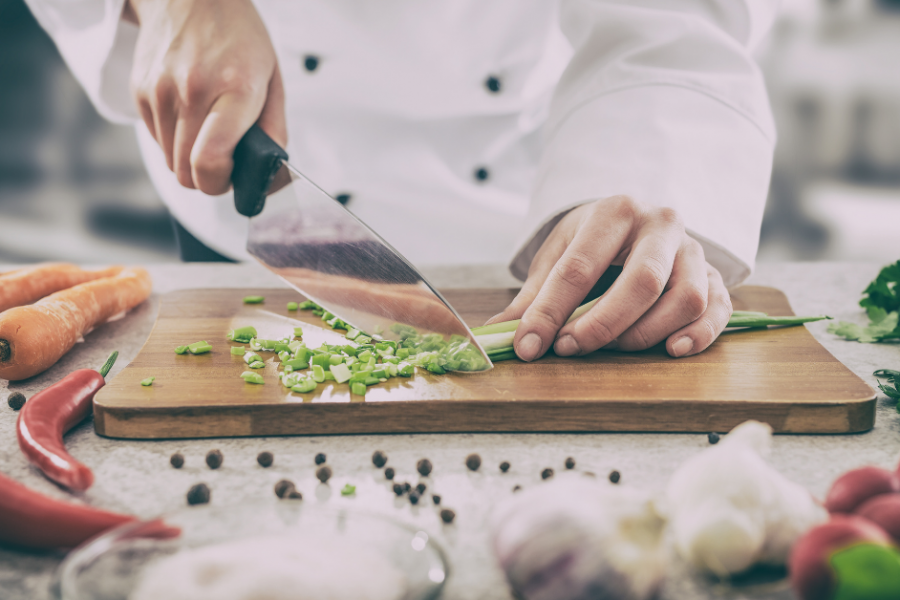 A cook preparing vegetables for a delicious dish
